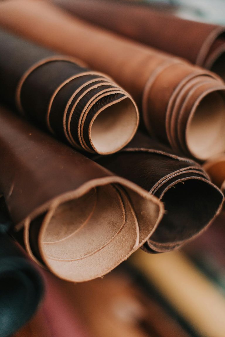 Detailed close-up of neatly rolled leather pieces, perfect for craft and design projects.