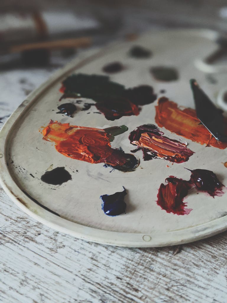 Close-up of a paint palette featuring vibrant and colorful acrylic paints.