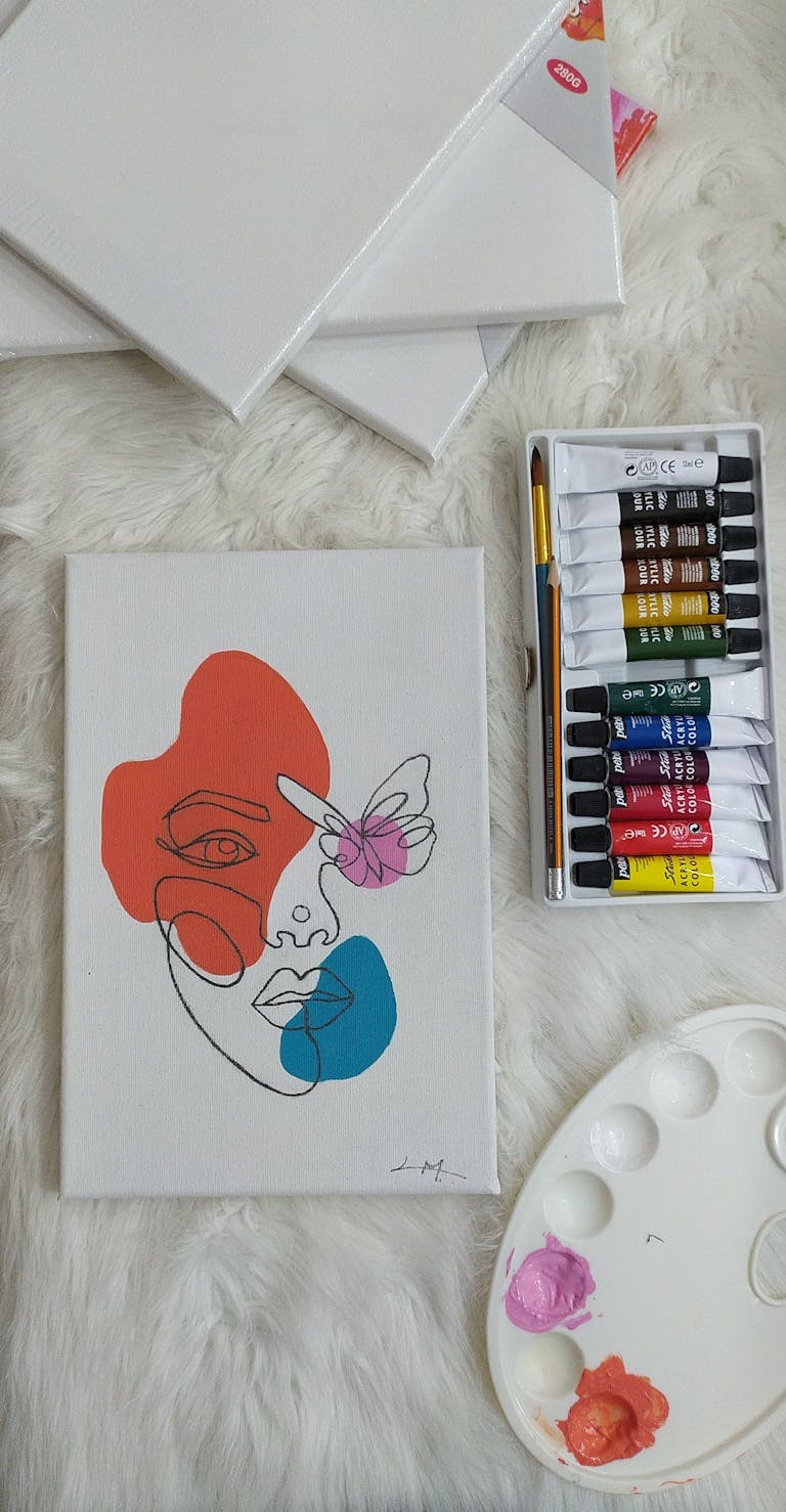 Top view of abstract art with paints and brushes, perfect for creative inspiration.